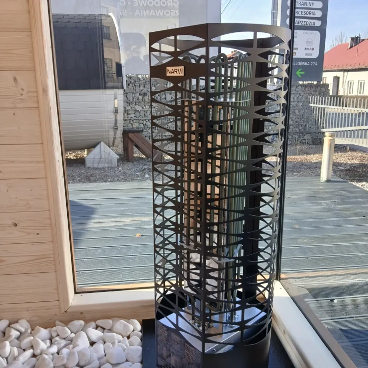 Widok na piec elektryczny 9 kW z kamieniami wewnątrz sauny z szybą narożną